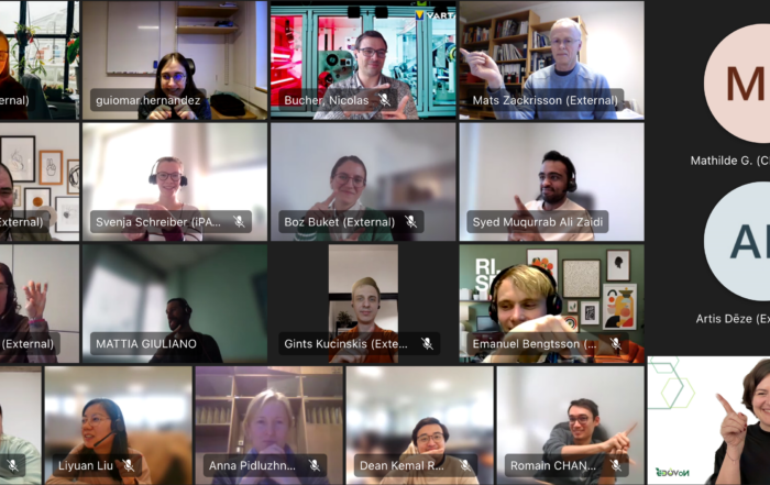 A screenshot of a video call with people pointing at each other