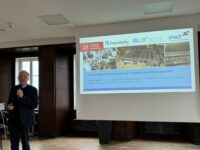 Prof Arno Kwade in front of a screen giving a talk